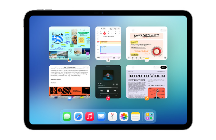 En iPad i vandret position, hvor skærmen viser seks åbne vinduer i to rækker, herunder Kalender, Noter, Apple Music og Safari